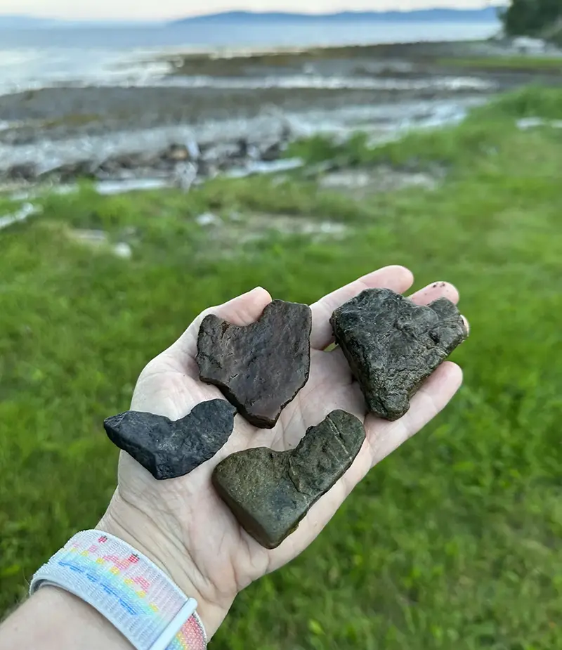 Melissa Boyd holds heart-shaped rocks outside the Limina Renewal Center